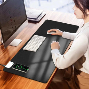 Wireless Charging Desk Mat on a desk with a laptop, keyboard, and phone charging wirelessly.