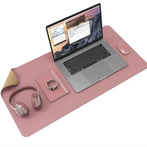 Large solid color cork leather desk pad with laptop and accessories.